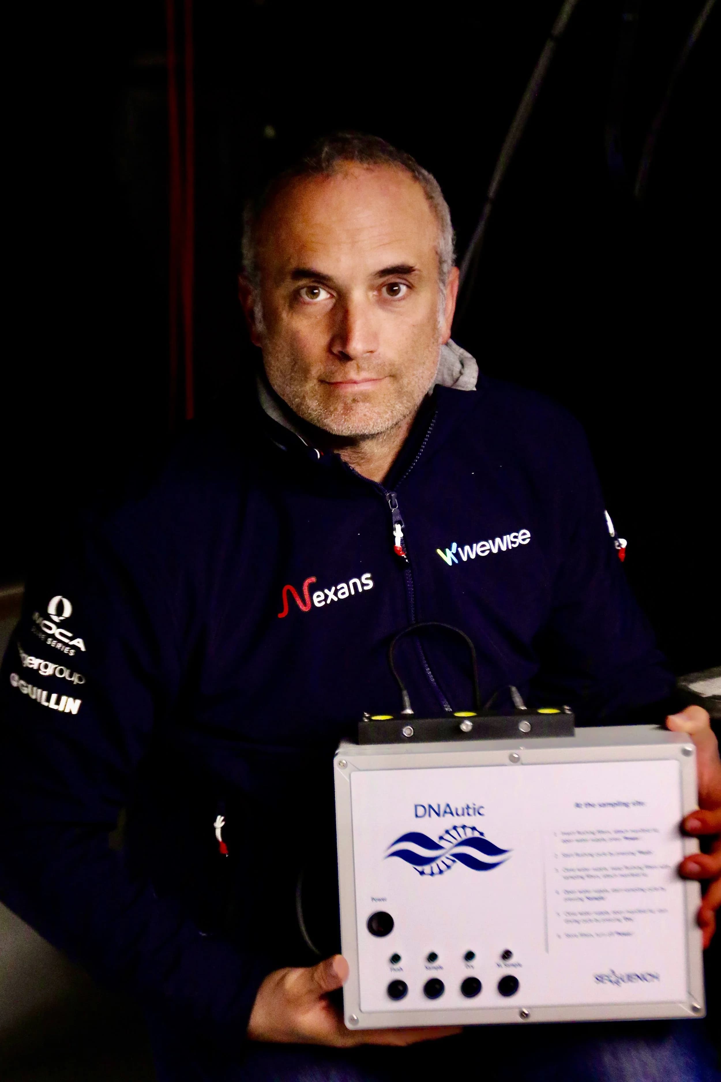 Vende Globe sailor Fabrice Amedeo with the DNAutic device for automatic eDNA filtering on an IMOCA offshore racing yacht.